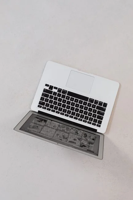 A stylish office desk arrangement showcasing Apple devices: iMac, MacBook, and iPad.
